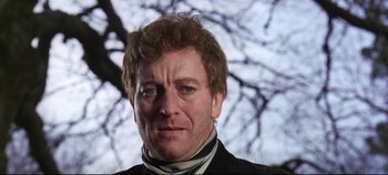 Movie still from “Ryan's Daughter” (1970), directed by David Lean – A person wearing a suit and tie; Close Up shot, Low angle