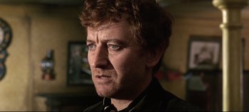 Movie still from “Ryan's Daughter” (1970), directed by David Lean – A person wearing a shirt and tie; Close Up shot, Over the shoulder angle