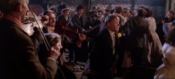 Movie still from “Ryan's Daughter” (1970), directed by David Lean – A group of people standing in a room; Medium shot, High angle