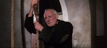 Movie still from “Ryan's Daughter” (1970), directed by David Lean – An older man holding a rope in his hand; Close Up shot, Low angle