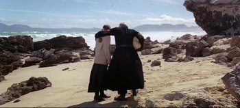 Movie still from “Ryan's Daughter” (1970), directed by David Lean – Two people standing on the beach looking out at the ocean; Wide shot, Low angle