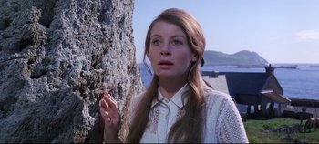 Movie still from “Ryan's Daughter” (1970), directed by David Lean – A woman in a white shirt is standing next to a tree; Close Up shot, Low angle