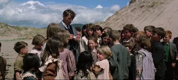 Movie still from “Ryan's Daughter” (1970), directed by David Lean – A group of people standing around each other on a hill; Medium shot, High angle