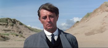 Movie still from “Ryan's Daughter” (1970), directed by David Lean – A person wearing a suit and tie; Close Up shot, Low angle