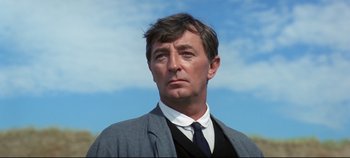 Movie still from “Ryan's Daughter” (1970), directed by David Lean – A person wearing a suit and tie; Close Up shot, Low angle