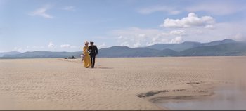 Movie still from “Ryan's Daughter” (1970), directed by David Lean – A man and a woman walking on the beach; Extreme Wide shot, Low angle