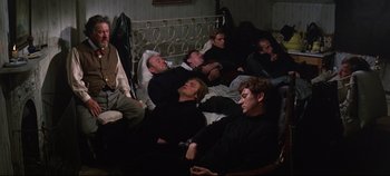 Movie still from “Ryan's Daughter” (1970), directed by David Lean – A group of people laying on a bed; Wide shot, High angle