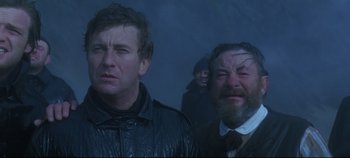 Movie still from “Ryan's Daughter” (1970), directed by David Lean – A group of men standing next to each other in the fog; Close Up shot, Low angle