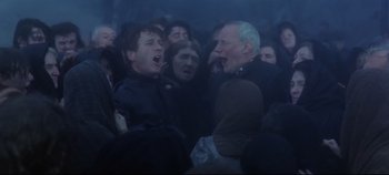 Movie still from “Ryan's Daughter” (1970), directed by David Lean – A group of people standing in the middle of a crowd; Medium shot, Low angle