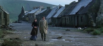 Movie still from “Ryan's Daughter” (1970), directed by David Lean – A man and a woman are walking in the dirt; Wide shot, High angle