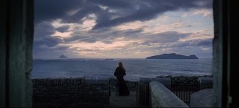 Movie still from “Ryan's Daughter” (1970), directed by David Lean – A woman standing on the edge of a pier looking out at the ocean; Extreme Wide shot, Low angle