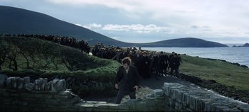 Movie still from “Ryan's Daughter” (1970), directed by David Lean – A crowd of people standing around a body of water; Extreme Wide shot, High angle