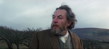 Movie still from “Ryan's Daughter” (1970), directed by David Lean – An older man with a beard and a jacket; Close Up shot, Low angle