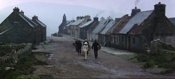 Movie still from “Ryan's Daughter” (1970), directed by David Lean – A group of people walking down a dirt road; Extreme Wide shot, High angle
