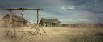 Movie still from “Godless” (2017), directed by Scott Frank – An old shack in the middle of a dirt field; Extreme Wide shot, Low angle