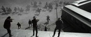 Movie still from “Godless” (2017), directed by Scott Frank – A group of men standing next to each other on horses; Wide shot, Low angle
