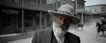 Movie still from “Godless” (2017), directed by Scott Frank – An old man with a white beard wearing a hat; Close Up shot, Low angle