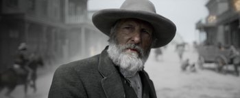 Movie still from “Godless” (2017), directed by Scott Frank – An old man with a white beard wearing a hat; Close Up shot, Low angle
