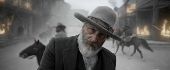 Movie still from “Godless” (2017), directed by Scott Frank – An old man with a beard wearing a hat; Close Up shot, Low angle