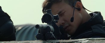 Movie still from “S.W.A.T.” (2003), directed by Clark Johnson – A man with a headset looking through a rifle scope; Close Up shot, Over the shoulder angle