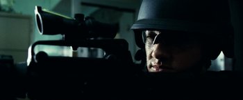 Movie still from “S.W.A.T.” (2003), directed by Clark Johnson – A man wearing a helmet and holding a rifle; Close Up shot, Low angle