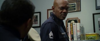 Movie still from “S.W.A.T.” (2003), directed by Clark Johnson – A man in a police uniform standing next to another man; Close Up shot, Over the shoulder angle