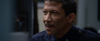 Movie still from “S.W.A.T.” (2003), directed by Clark Johnson – A person wearing a police uniform; Close Up shot, High angle