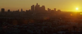 Movie still from “S.W.A.T.” (2003), directed by Clark Johnson – A view of a city skyline at sunset from a hill; Extreme Wide shot, Low angle