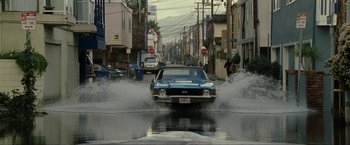 Movie still from “S.W.A.T.” (2003), directed by Clark Johnson – A car drives through a flooded street in a city; Wide shot, High angle