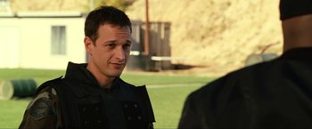 Movie still from “S.W.A.T.” (2003), directed by Clark Johnson – A man in a black jacket is talking to someone; Close Up shot, Over the shoulder angle