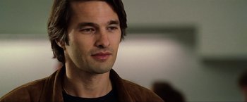 Movie still from “S.W.A.T.” (2003), directed by Clark Johnson – A person wearing a brown jacket; Close Up shot, Over the shoulder angle