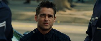 Movie still from “S.W.A.T.” (2003), directed by Clark Johnson – A man with spiky hair wearing a police uniform; Close Up shot, Over the shoulder angle