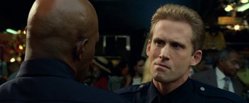 Movie still from “S.W.A.T.” (2003), directed by Clark Johnson – A police officer talking to another officer in the background; Close Up shot, Over the shoulder angle