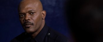 Movie still from “S.W.A.T.” (2003), directed by Clark Johnson – A man in a police uniform is looking at the camera; Close Up shot, Low angle