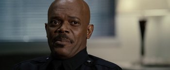 Movie still from “S.W.A.T.” (2003), directed by Clark Johnson – A person wearing a police uniform; Close Up shot, Low angle