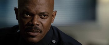 Movie still from “S.W.A.T.” (2003), directed by Clark Johnson – A man's face in a black shirt; Close Up shot, Low angle