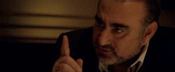 Movie still from “S.W.A.T.” (2003), directed by Clark Johnson – A person wearing a suit and tie; Close Up shot, Over the shoulder angle