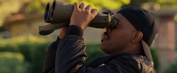 Movie still from “S.W.A.T.” (2003), directed by Clark Johnson – A man looking through a pair of binoculars; Close Up shot, Low angle
