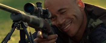 Movie still from “S.W.A.T.” (2003), directed by Clark Johnson – A man is looking through a rifle scope; Close Up shot, Over the shoulder angle