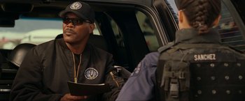 Movie still from “S.W.A.T.” (2003), directed by Clark Johnson – A man sitting in the back of a vehicle; Close Up shot, Over the shoulder angle
