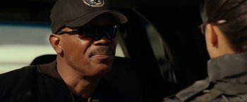 Movie still from “S.W.A.T.” (2003), directed by Clark Johnson – A person wearing sunglasses and a hat; Close Up shot, Over the shoulder angle
