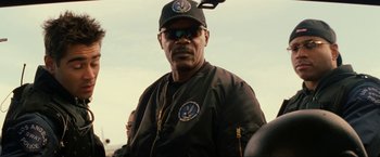 Movie still from “S.W.A.T.” (2003), directed by Clark Johnson – A man in a black jacket and a hat; Close Up shot, Over the shoulder angle