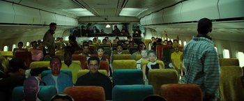 Movie still from “S.W.A.T.” (2003), directed by Clark Johnson – A group of people sitting on a plane; Wide shot, High angle