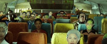 Movie still from “S.W.A.T.” (2003), directed by Clark Johnson – A group of people sitting on a bus with their heads cut out of the seats; Wide shot, High angle
