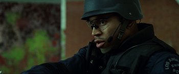 Movie still from “S.W.A.T.” (2003), directed by Clark Johnson – A man wearing a helmet and a black jacket; Close Up shot, Over the shoulder angle