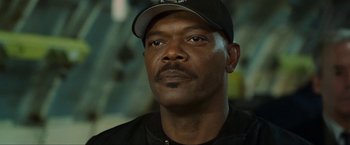 Movie still from “S.W.A.T.” (2003), directed by Clark Johnson – A person wearing a hat; Close Up shot, Over the shoulder angle