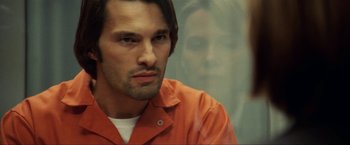 Movie still from “S.W.A.T.” (2003), directed by Clark Johnson – A man in an orange prison uniform looking at the camera; Close Up shot, Over the shoulder angle