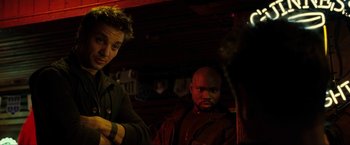 Movie still from “S.W.A.T.” (2003), directed by Clark Johnson – Two men are standing in a dark room; Medium shot, Over the shoulder angle