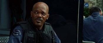 Movie still from “S.W.A.T.” (2003), directed by Clark Johnson – A man in a police uniform looking at the camera; Close Up shot, Low angle