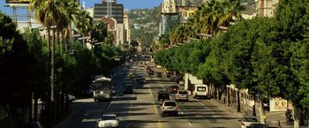 Movie still from “S.W.A.T.” (2003), directed by Clark Johnson – A city street filled with lots of traffic and palm trees on both sides of the street; Extreme Wide shot, High angle
